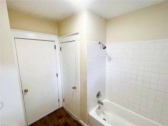 bathroom featuring tub / shower combination and wood finished floors