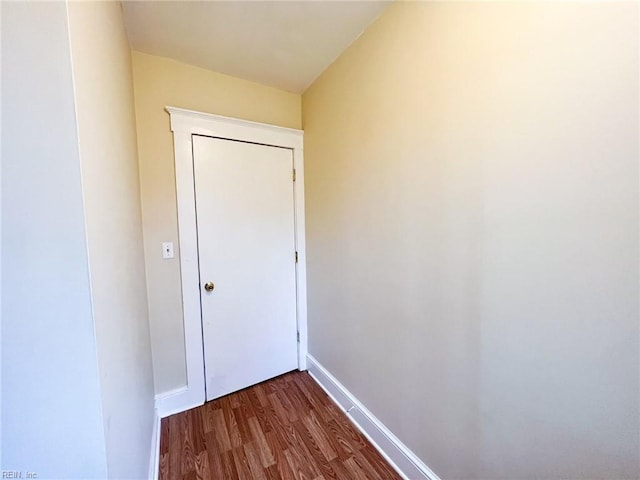 doorway to outside with baseboards and dark wood finished floors