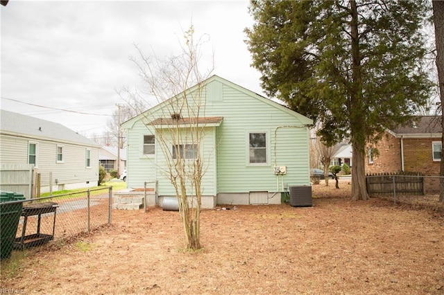 rear view of property with fence and central AC unit