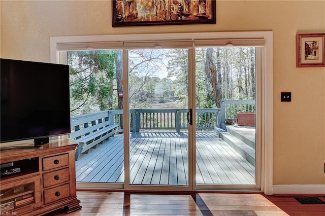 entryway with baseboards and wood finished floors