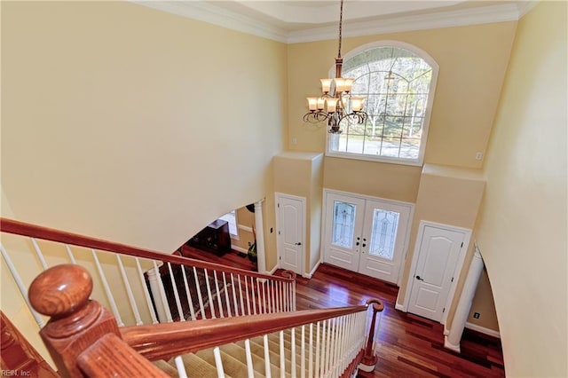 foyer entrance with french doors, stairway, an inviting chandelier, and crown molding