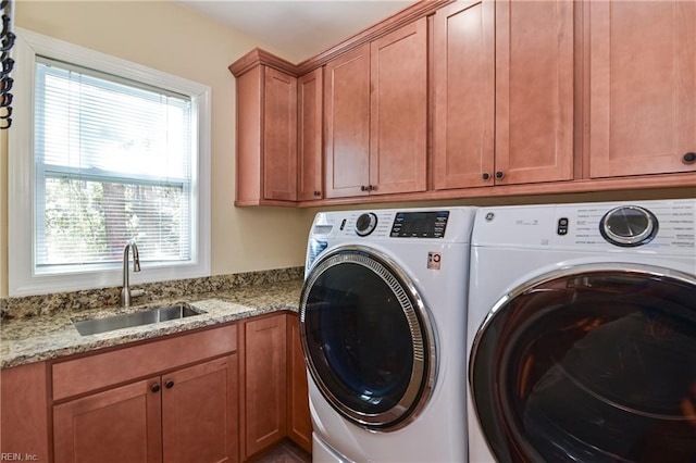 laundry room featuring a sink, cabinet space, and washer and dryer