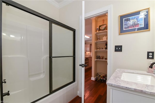 full bathroom with crown molding, shower / bath combination with glass door, vanity, and wood finished floors