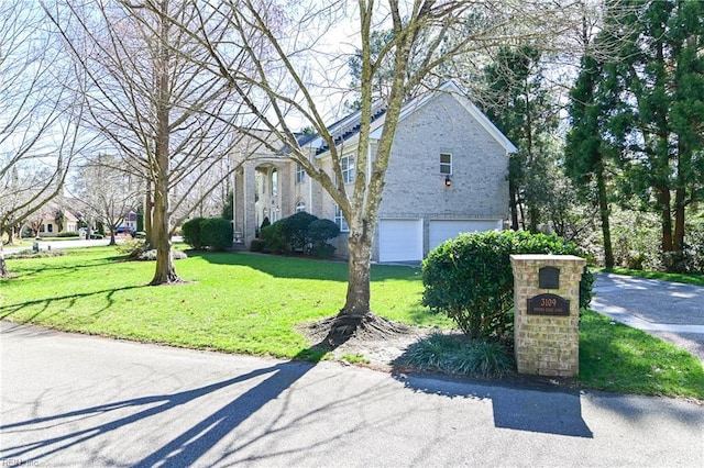 view of property exterior featuring a yard and an attached garage