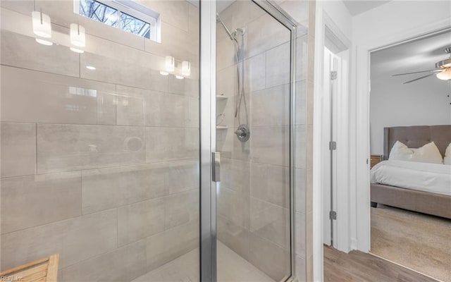 full bathroom with ceiling fan, a shower stall, ensuite bath, and wood finished floors