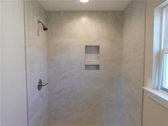 full bathroom with a tile shower