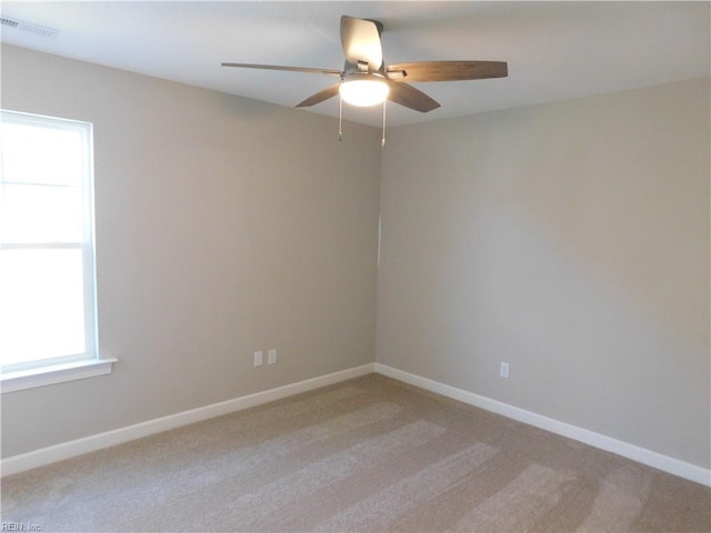 unfurnished room featuring ceiling fan, baseboards, and light colored carpet