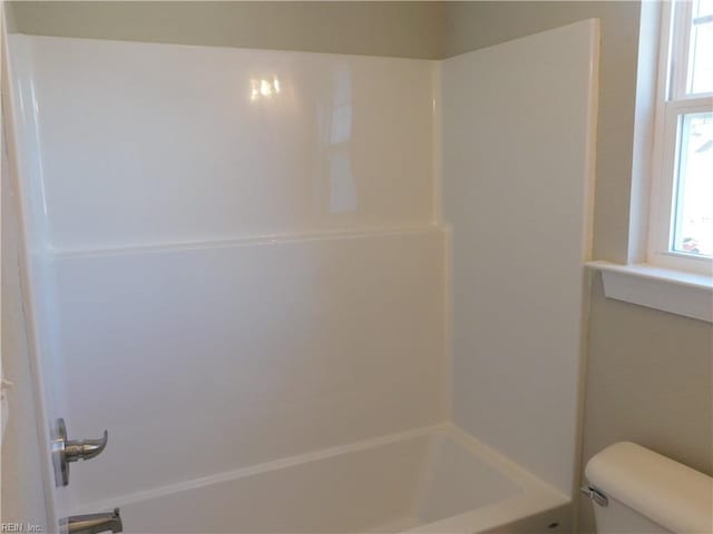 full bath with toilet, a wealth of natural light, and shower / bathing tub combination