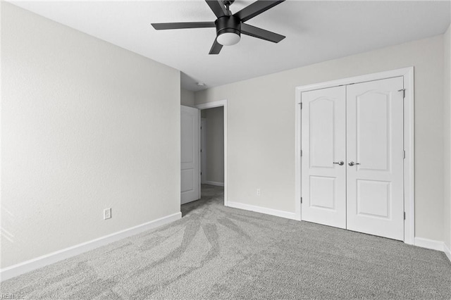 unfurnished bedroom featuring a closet, carpet flooring, a ceiling fan, and baseboards