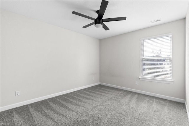 spare room featuring a ceiling fan, carpet, visible vents, and baseboards