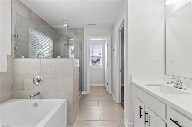 bathroom with visible vents, tile patterned floors, vanity, a shower stall, and a bath