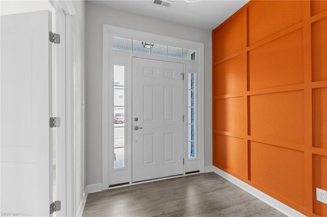 entryway with wood finished floors