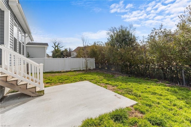 view of yard with a patio area and a fenced backyard