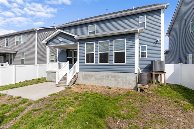 rear view of property with a patio and a fenced backyard