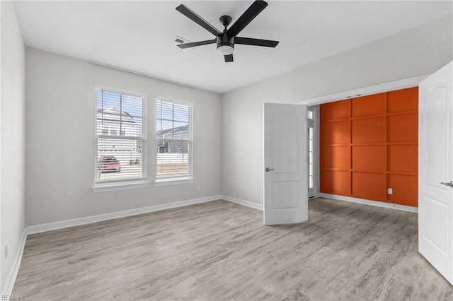 unfurnished bedroom with visible vents, ceiling fan, light wood-style flooring, and baseboards