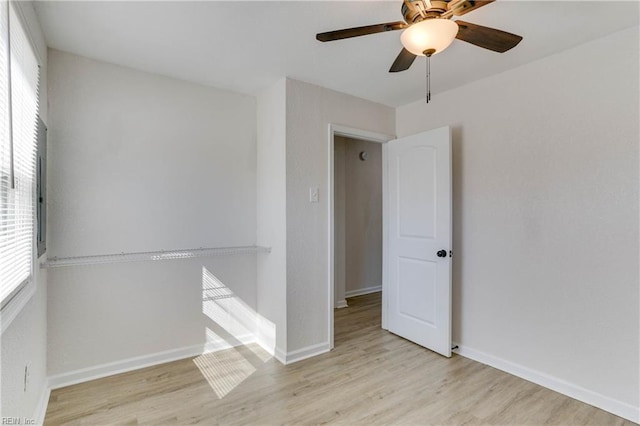 unfurnished room featuring baseboards, ceiling fan, and light wood-style floors