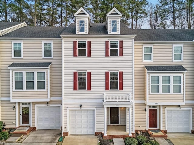 multi unit property featuring driveway, a shingled roof, and a garage