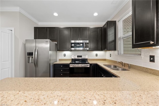 kitchen with crown molding, decorative backsplash, appliances with stainless steel finishes, a sink, and dark cabinets