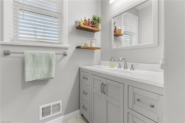 bathroom with marble finish floor, visible vents, and vanity