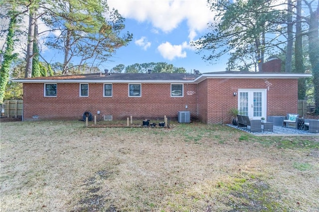 rear view of house with crawl space, french doors, a patio, and brick siding