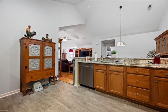 kitchen with brown cabinetry, decorative light fixtures, dishwasher, and a sink