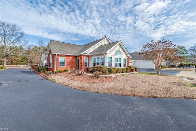 single story home with brick siding and driveway