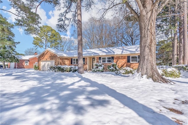 view of front of home featuring a garage and brick siding