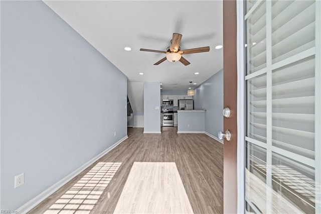 unfurnished living room with light wood-style floors, recessed lighting, ceiling fan, and baseboards