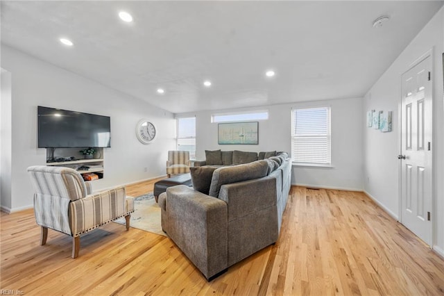 living area with light wood finished floors, recessed lighting, and a healthy amount of sunlight