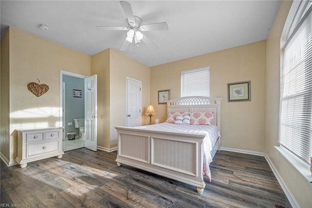 bedroom with ceiling fan, dark wood-type flooring, and baseboards