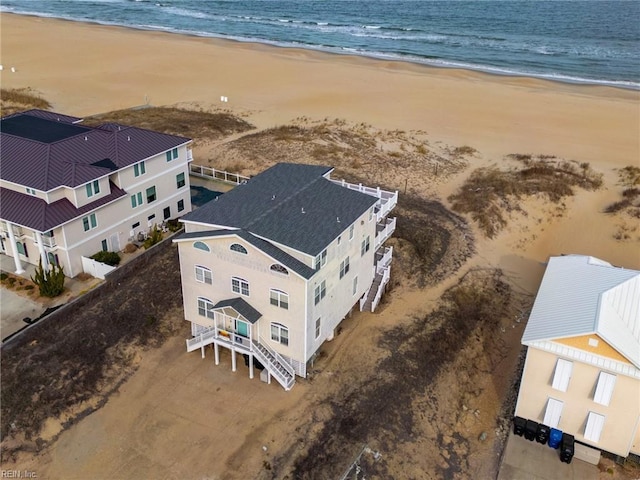 aerial view with a water view and a beach view