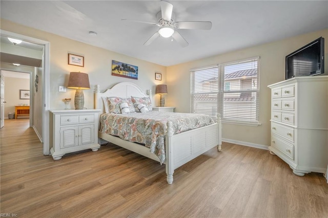 bedroom with ceiling fan, light wood-type flooring, and baseboards