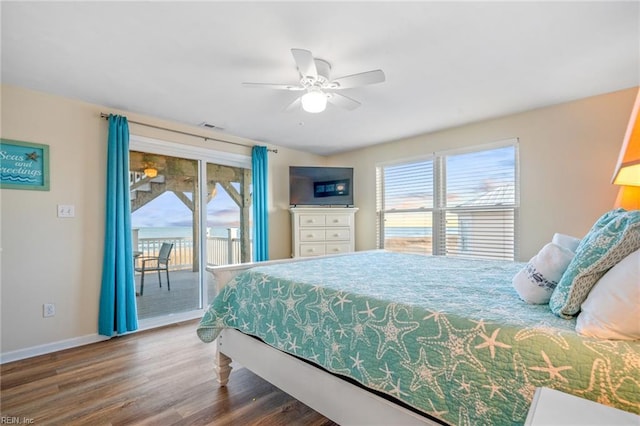 bedroom with access to outside, multiple windows, visible vents, and wood finished floors