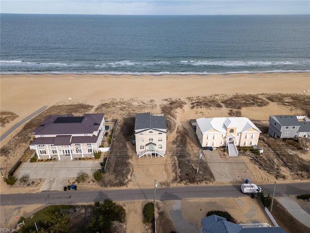 birds eye view of property with a water view and a view of the beach