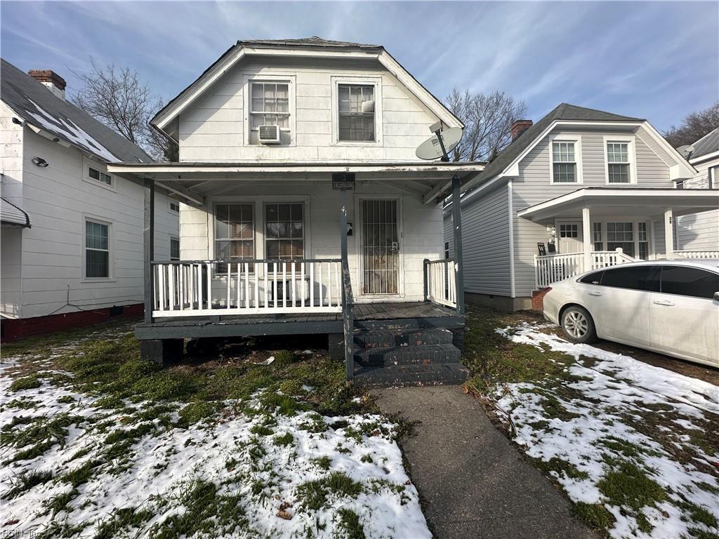 view of front of home with covered porch and cooling unit