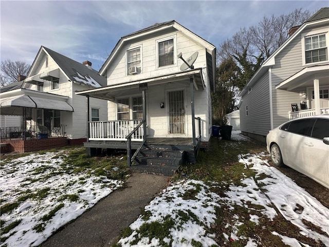 view of front of property featuring covered porch and cooling unit