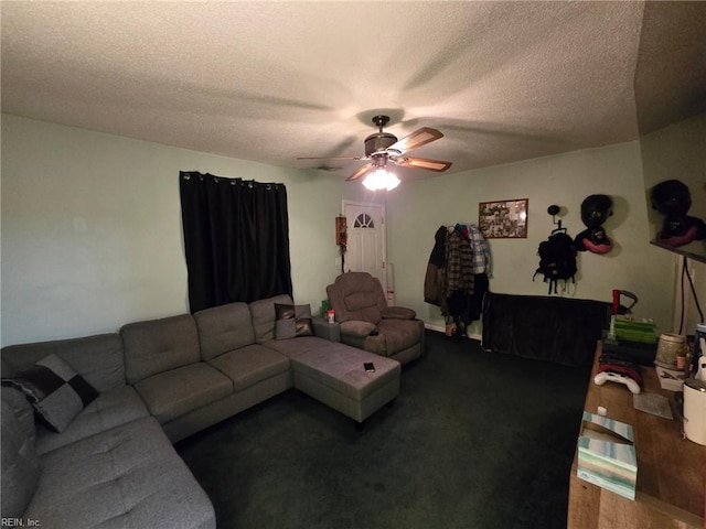 living area with dark wood-style flooring, ceiling fan, and a textured ceiling