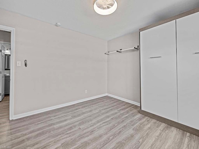 interior space with light wood-type flooring and baseboards