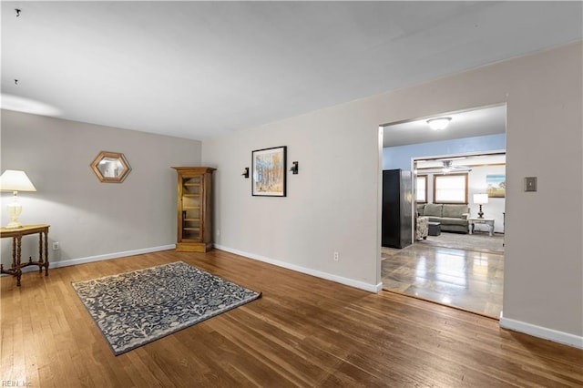 interior space with baseboards and wood-type flooring