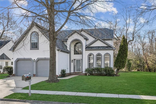 view of front of property with a shingled roof, a front yard, driveway, and an attached garage