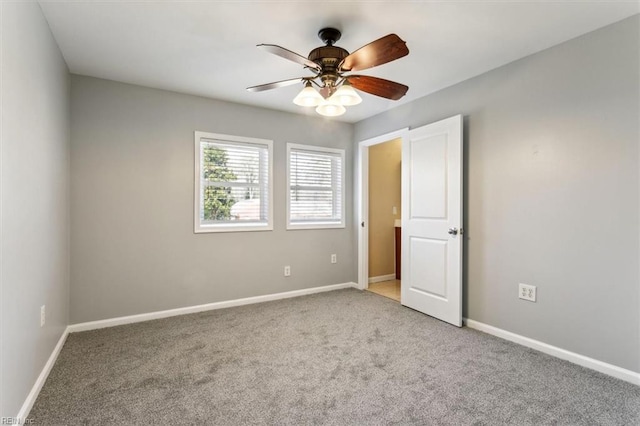 unfurnished bedroom featuring a ceiling fan, light colored carpet, and baseboards