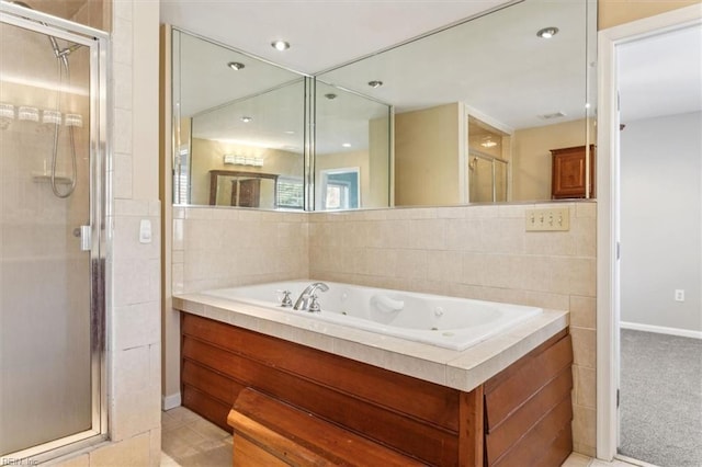 full bathroom featuring a tub with jets and a stall shower