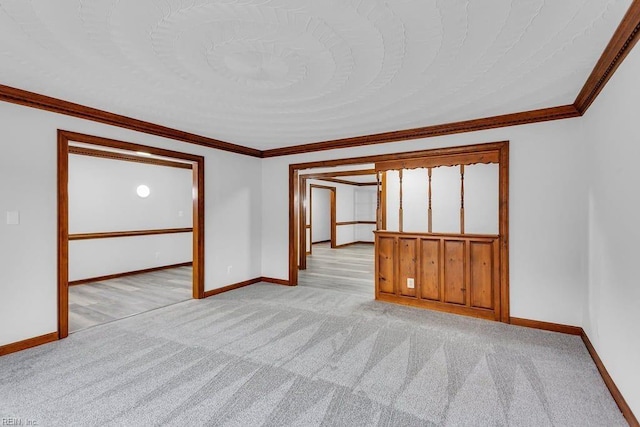 unfurnished room featuring light colored carpet, crown molding, and baseboards