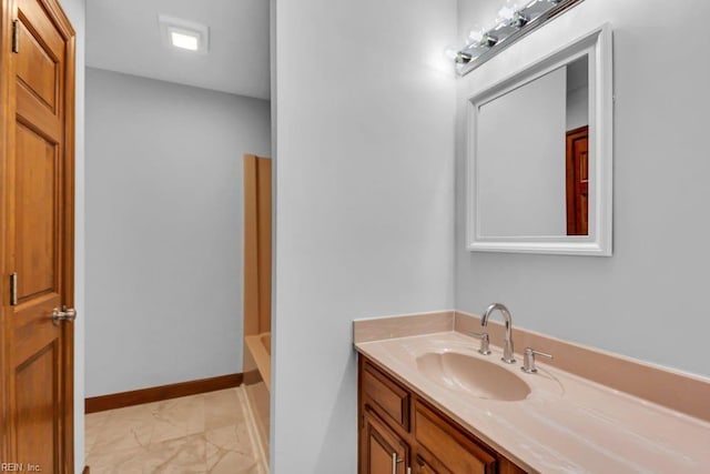 full bathroom with a washtub, vanity, and baseboards