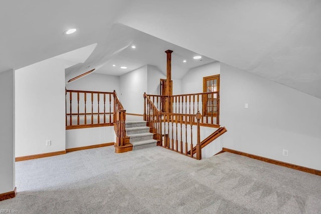 additional living space featuring recessed lighting, light colored carpet, vaulted ceiling, and baseboards