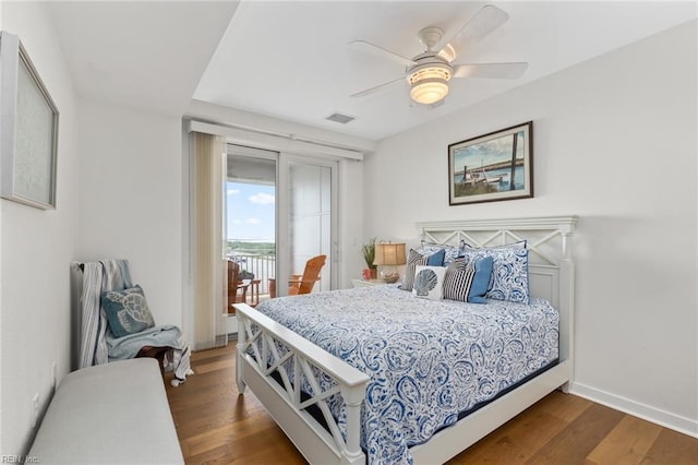 bedroom featuring access to exterior, baseboards, visible vents, and dark wood-style flooring