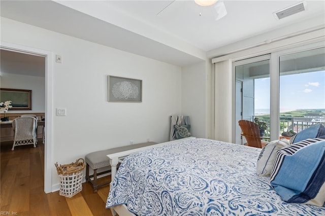 bedroom featuring a ceiling fan, access to outside, visible vents, and wood finished floors