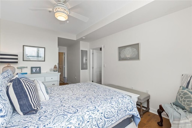 bedroom with ceiling fan, baseboards, and wood finished floors