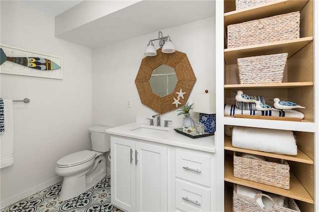 bathroom featuring tile patterned flooring, baseboards, vanity, and toilet