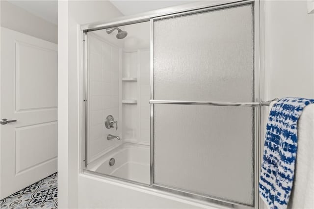 bathroom featuring combined bath / shower with glass door